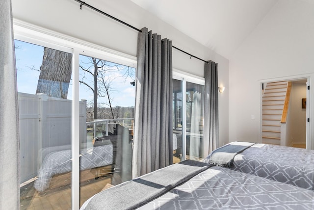 2060 S Algonquin Dr, Benton Harbor, MI 49022 - bedroom featuring wood finished floors, lofted ceiling, access to exterior, and multiple windows