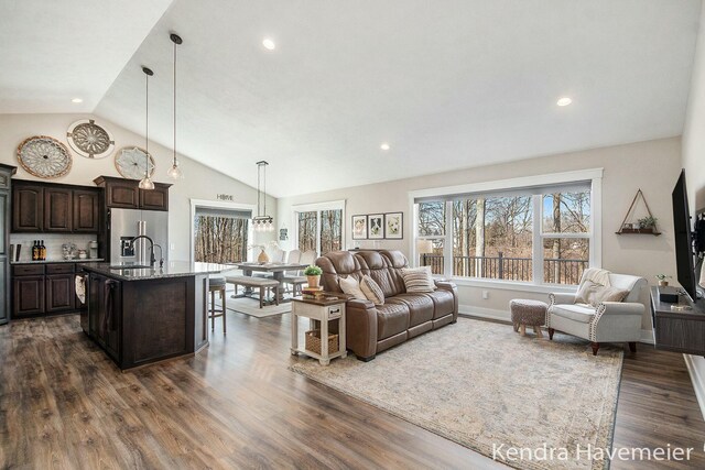 living room featuring recessed lighting, dark wood-style floors, and high vaulted ceiling