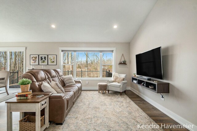 living room with recessed lighting, baseboards, lofted ceiling, and wood finished floors