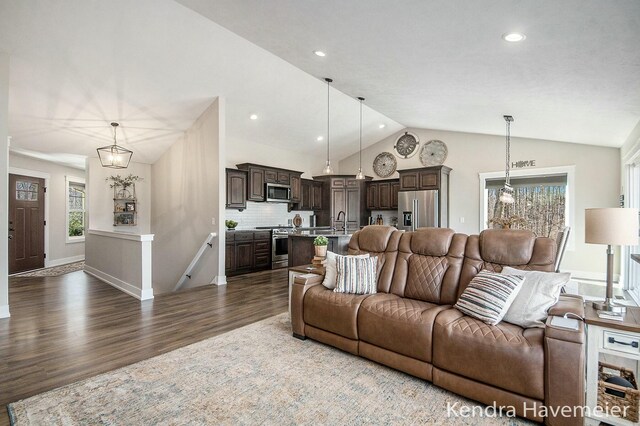 living area with recessed lighting, baseboards, lofted ceiling, and dark wood-style flooring