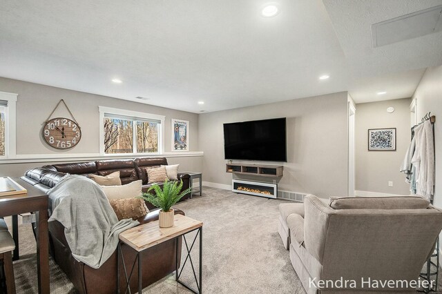 carpeted living room with visible vents, recessed lighting, and baseboards