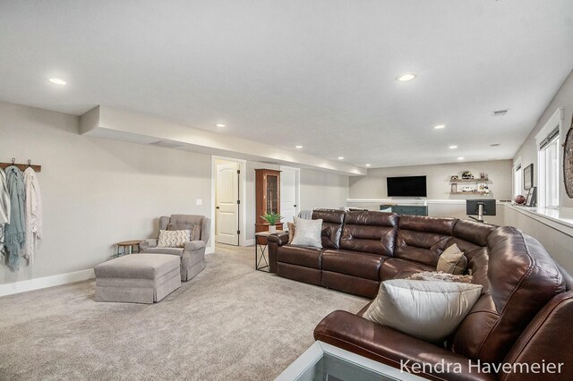 living room with recessed lighting, visible vents, baseboards, and light colored carpet