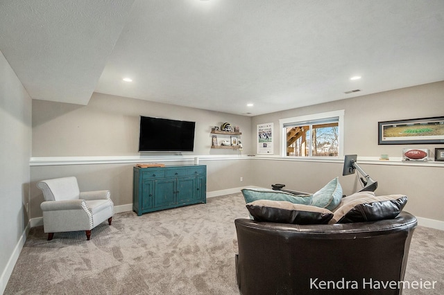 living area featuring recessed lighting, visible vents, baseboards, and light colored carpet