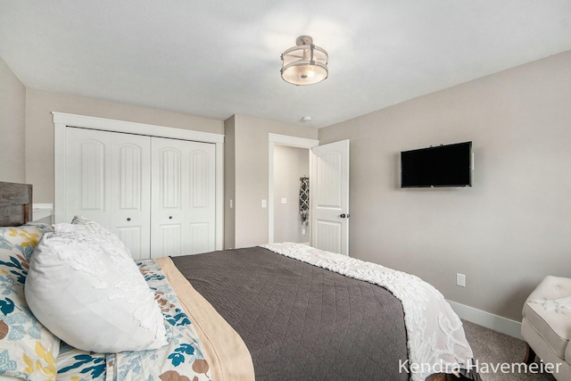 bedroom with a closet, baseboards, and carpet