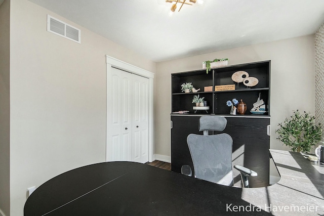 office area featuring visible vents and wood finished floors