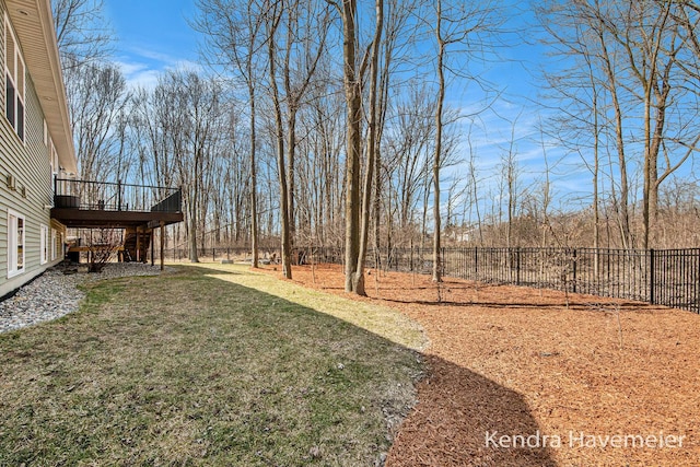 view of yard with a deck, stairs, and fence