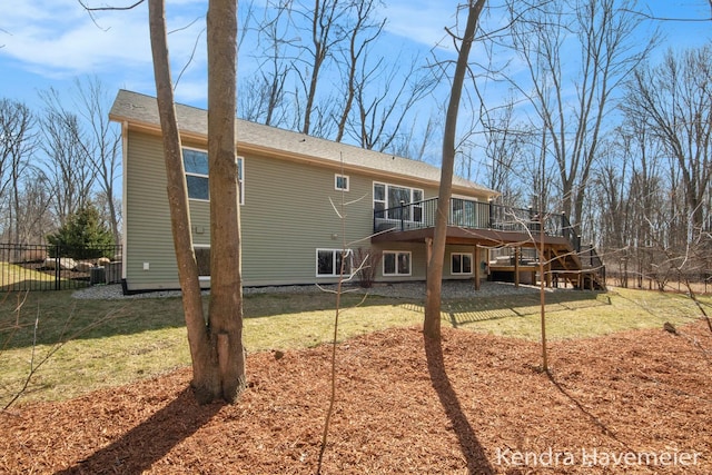 back of house featuring stairway, a lawn, a deck, and fence