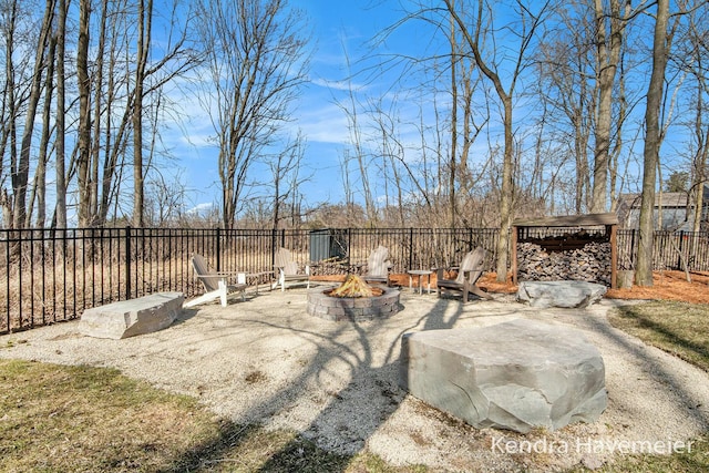 view of patio with a fire pit and fence