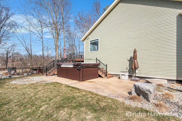 view of side of property featuring a yard, a patio, a wooden deck, and a hot tub