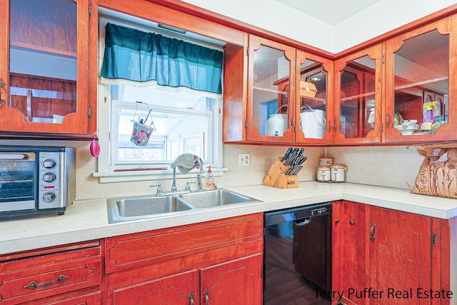 kitchen with a toaster, dishwasher, light countertops, and a sink