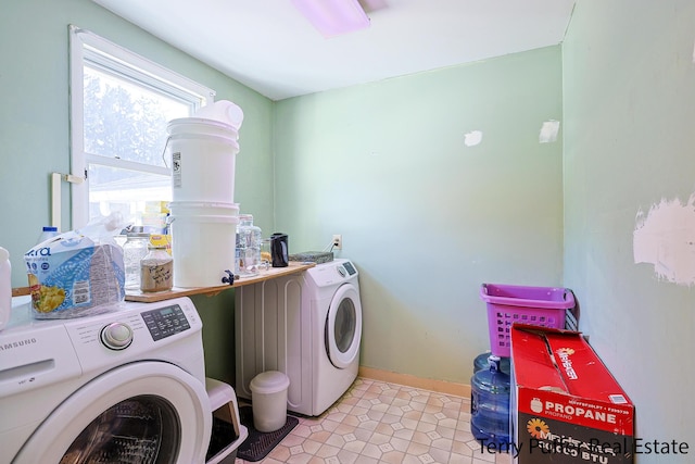 laundry room featuring laundry area, baseboards, and washing machine and clothes dryer