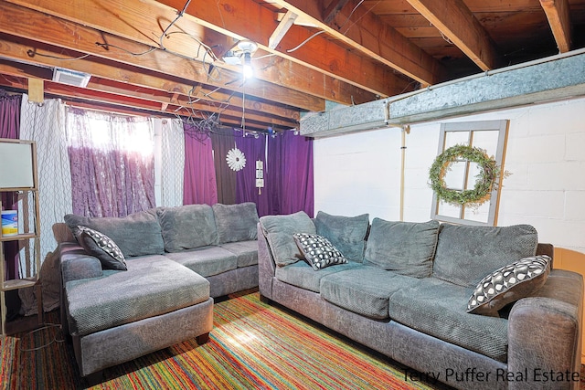 living room featuring visible vents and concrete block wall