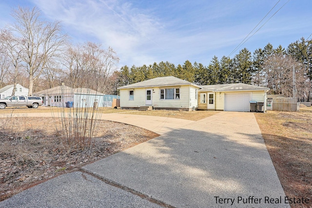 view of front of home featuring an attached garage, fence, driveway, and crawl space