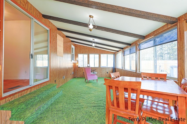 sunroom featuring lofted ceiling with beams