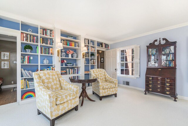 living area with crown molding, baseboards, visible vents, and carpet flooring