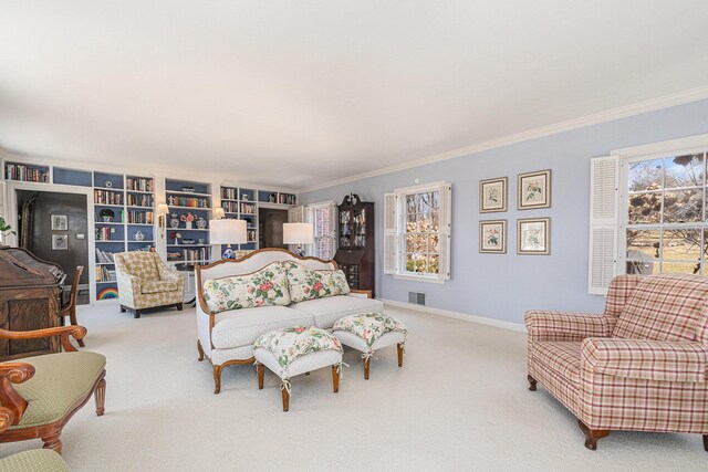 carpeted living area featuring baseboards, visible vents, and ornamental molding