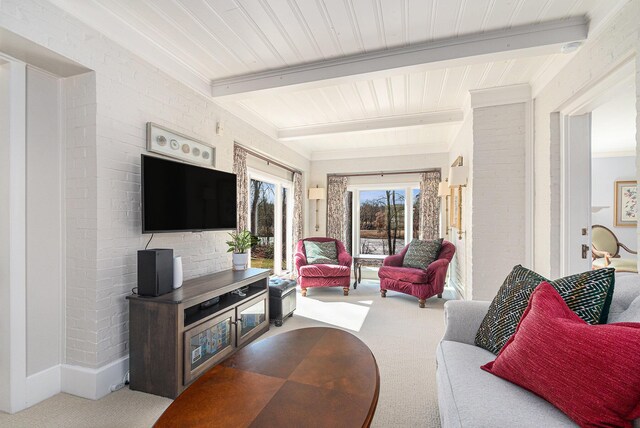living area featuring carpet flooring and beamed ceiling