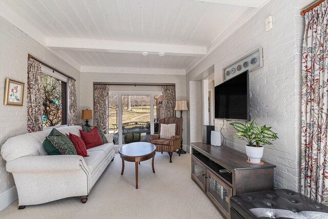 living room featuring plenty of natural light, beamed ceiling, and light colored carpet
