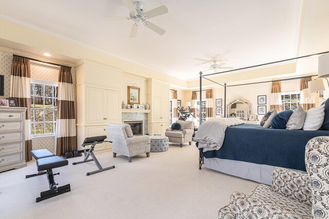 carpeted bedroom with crown molding and a fireplace