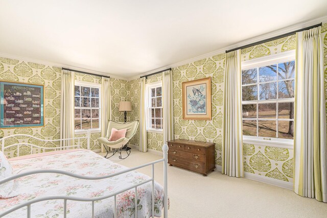 carpeted bedroom featuring wallpapered walls, ornamental molding, and baseboards