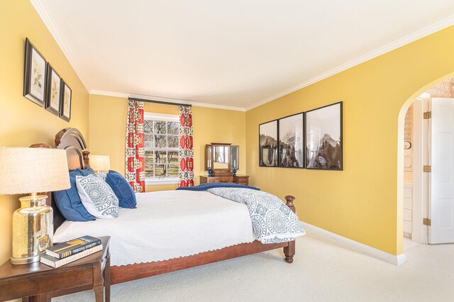 carpeted bedroom featuring crown molding, arched walkways, and baseboards