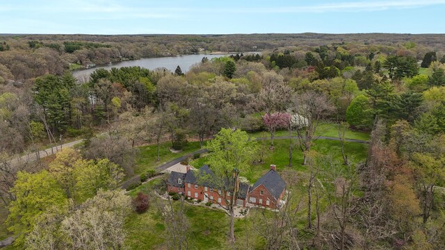 aerial view with a water view and a forest view