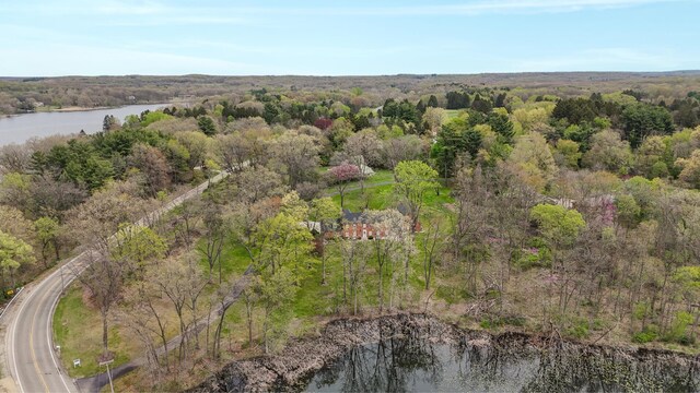 drone / aerial view featuring a water view and a wooded view