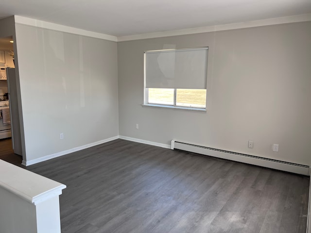 empty room with baseboard heating, ornamental molding, baseboards, and dark wood-style flooring