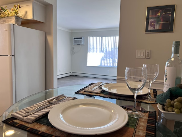 dining area with crown molding, a wall mounted AC, and a baseboard heating unit