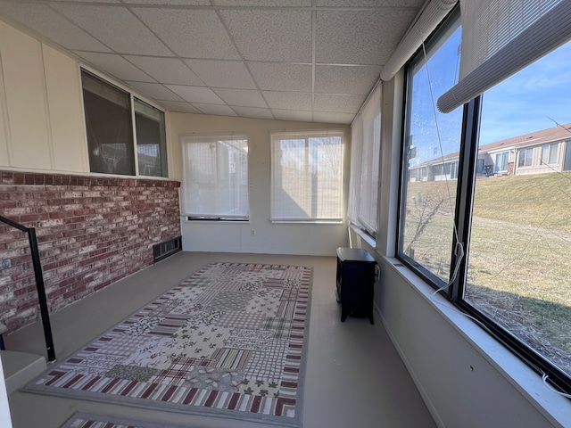 unfurnished sunroom featuring visible vents and a paneled ceiling