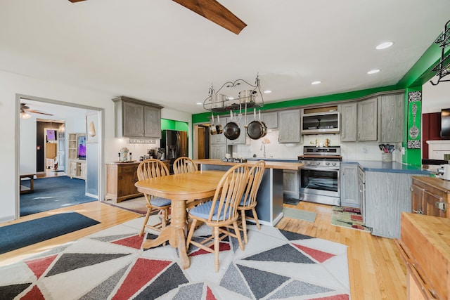 dining room featuring a ceiling fan, recessed lighting, and light wood finished floors