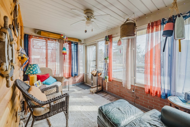 sunroom / solarium featuring ceiling fan