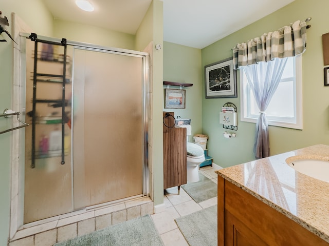 bathroom featuring tile patterned floors, toilet, a stall shower, and vanity