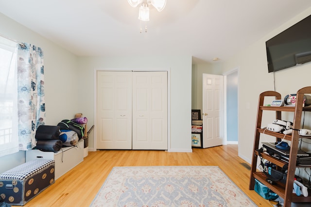 interior space featuring wood finished floors, baseboards, and ceiling fan