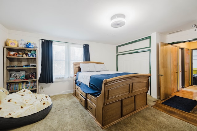 bedroom featuring light carpet, visible vents, and baseboards