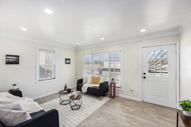 sitting room featuring plenty of natural light, baseboards, and light wood-type flooring