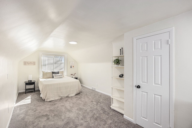 bedroom with visible vents, baseboards, carpet, and vaulted ceiling