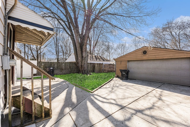 exterior space featuring a garage, an outdoor structure, and fence