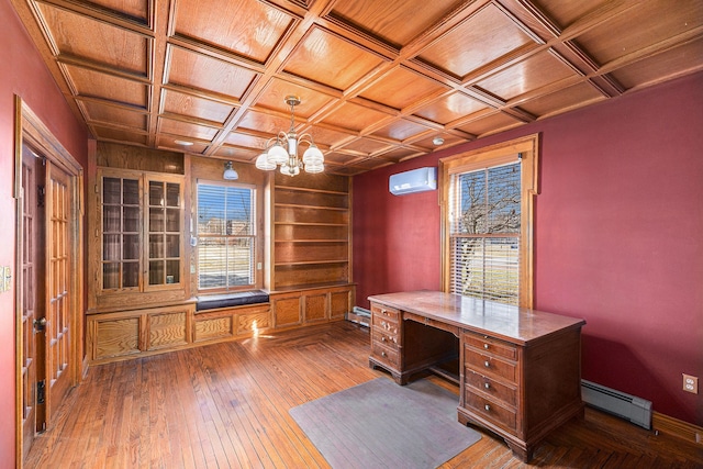 unfurnished office featuring a chandelier, an AC wall unit, baseboard heating, coffered ceiling, and wood-type flooring