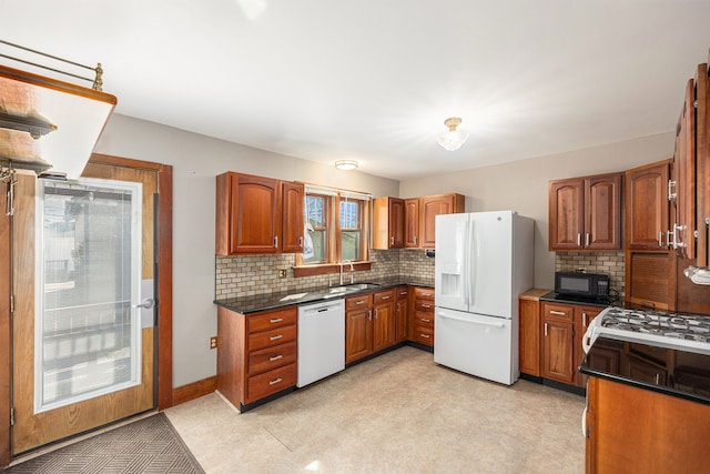 kitchen with white appliances, brown cabinets, backsplash, and a sink