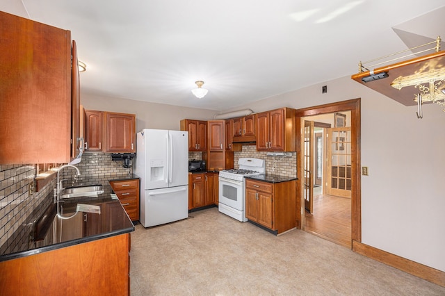 kitchen featuring a sink, dark countertops, white appliances, brown cabinetry, and light floors