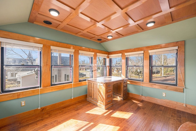 unfurnished office featuring vaulted ceiling with beams, plenty of natural light, and wood-type flooring