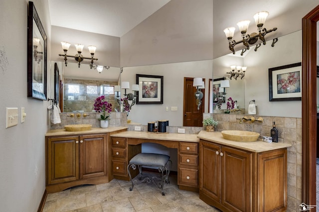 full bathroom featuring double vanity, a notable chandelier, and a sink