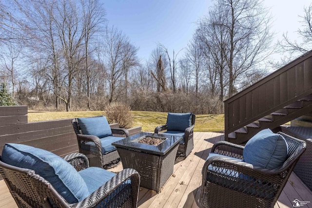 deck featuring an outdoor living space with a fire pit