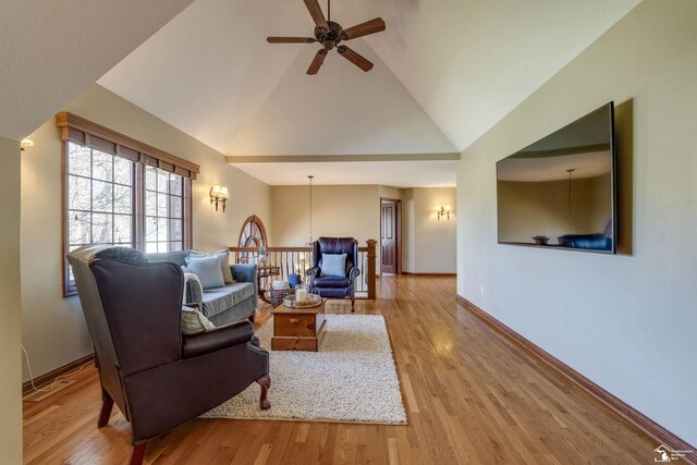 living room with high vaulted ceiling, baseboards, ceiling fan, and wood finished floors