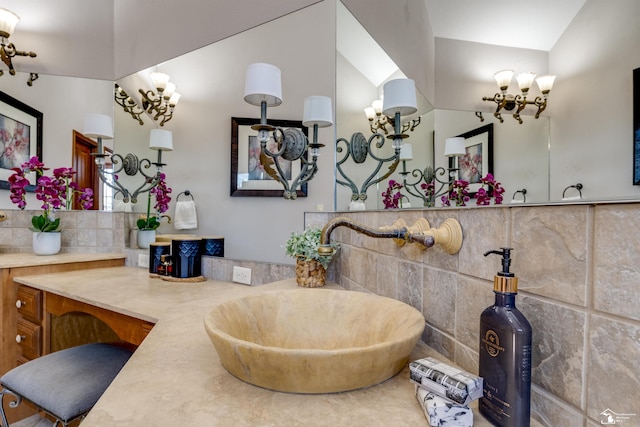 bathroom with vanity and vaulted ceiling