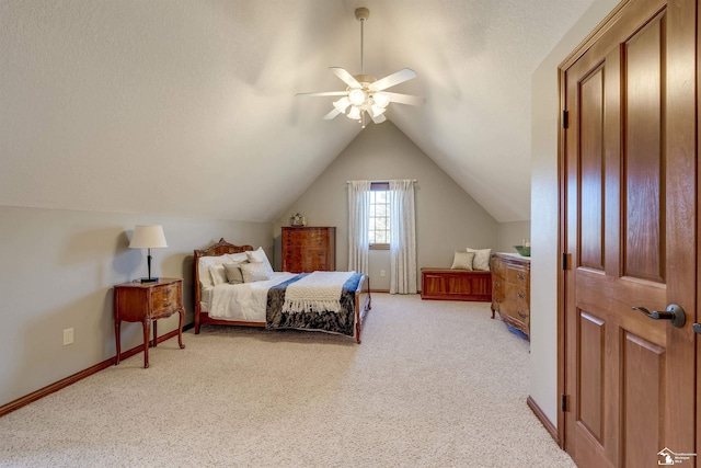 bedroom featuring baseboards, lofted ceiling, ceiling fan, a textured ceiling, and light colored carpet