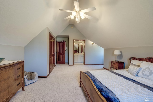 bedroom with ceiling fan, baseboards, light colored carpet, vaulted ceiling, and ensuite bath