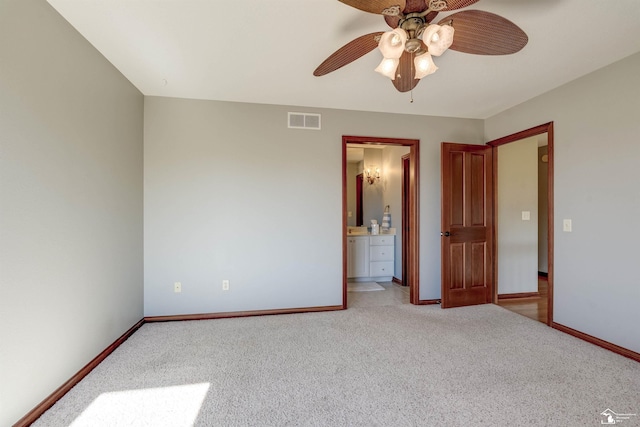 unfurnished bedroom with baseboards, visible vents, carpet floors, and connected bathroom