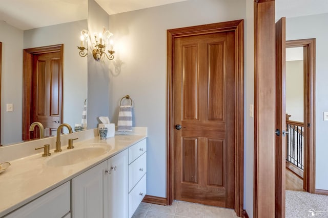 bathroom featuring tile patterned flooring, vanity, and baseboards